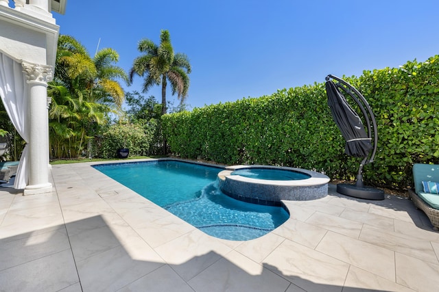 712 NE 71st St, Boca Raton, FL 33487 - view of pool with a patio area and a pool with connected hot tub
