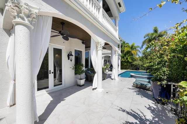 712 NE 71st St, Boca Raton, FL 33487 - view of patio with a ceiling fan, a pool with connected hot tub, and french doors