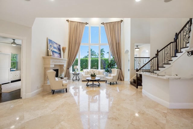 712 NE 71st St, Boca Raton, FL 33487 - interior space featuring a towering ceiling, marble finish floor, stairs, ceiling fan, and a fireplace