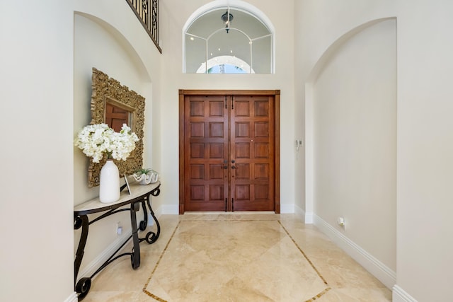 712 NE 71st St, Boca Raton, FL 33487 - foyer with baseboards, a high ceiling, and marble finish floor