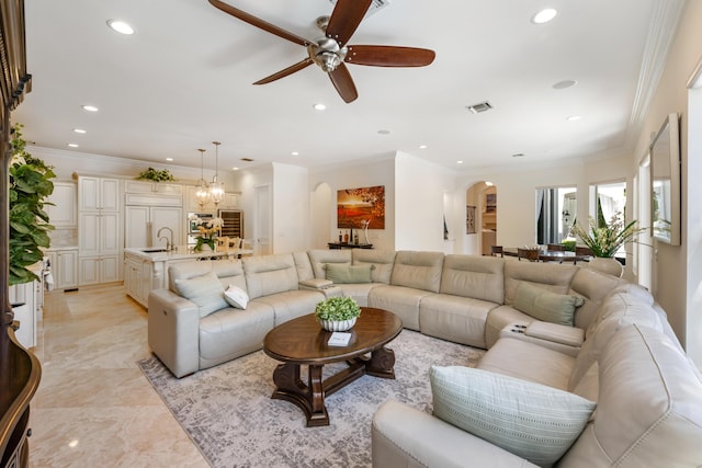 712 NE 71st St, Boca Raton, FL 33487 - living room featuring arched walkways, visible vents, recessed lighting, ceiling fan with notable chandelier, and crown molding
