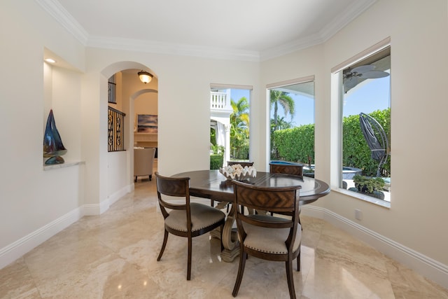 712 NE 71st St, Boca Raton, FL 33487 - dining area with arched walkways, plenty of natural light, crown molding, and baseboards