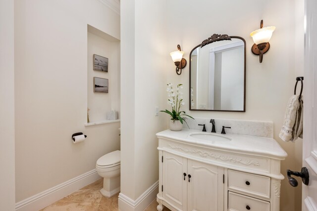 712 NE 71st St, Boca Raton, FL 33487 - bathroom with vanity, baseboards, and toilet