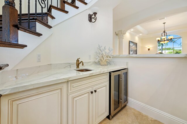 712 NE 71st St, Boca Raton, FL 33487 - bar featuring arched walkways, a sink, an inviting chandelier, pendant lighting, and beverage cooler
