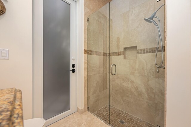 712 NE 71st St, Boca Raton, FL 33487 - bathroom featuring toilet, a stall shower, and tile patterned floors