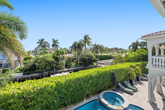 712 NE 71st St, Boca Raton, FL 33487 - view of swimming pool featuring a patio area and an in ground hot tub