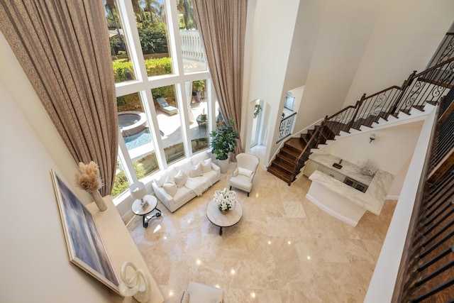 712 NE 71st St, Boca Raton, FL 33487 - living room with marble finish floor, a high ceiling, and stairs