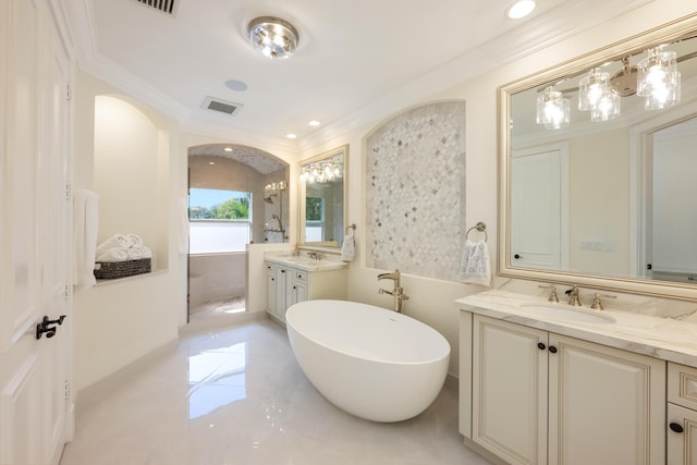 712 NE 71st St, Boca Raton, FL 33487 - full bath with a soaking tub, a sink, two vanities, visible vents, and ornamental molding