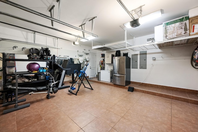 712 NE 71st St, Boca Raton, FL 33487 - garage featuring electric panel, freestanding refrigerator, and a garage door opener