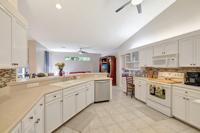 2857 SE Pace Dr, Port Saint Lucie, FL 34984 - kitchen with white appliances, a ceiling fan, lofted ceiling, decorative backsplash, and a sink