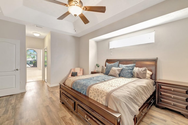 2857 SE Pace Dr, Port Saint Lucie, FL 34984 - bedroom with a raised ceiling, ceiling fan, baseboards, and light wood-style flooring