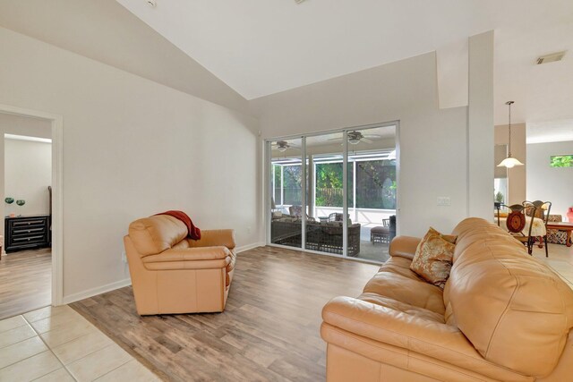2857 SE Pace Dr, Port Saint Lucie, FL 34984 - living room with baseboards, light wood-type flooring, visible vents, high vaulted ceiling, and a sunroom