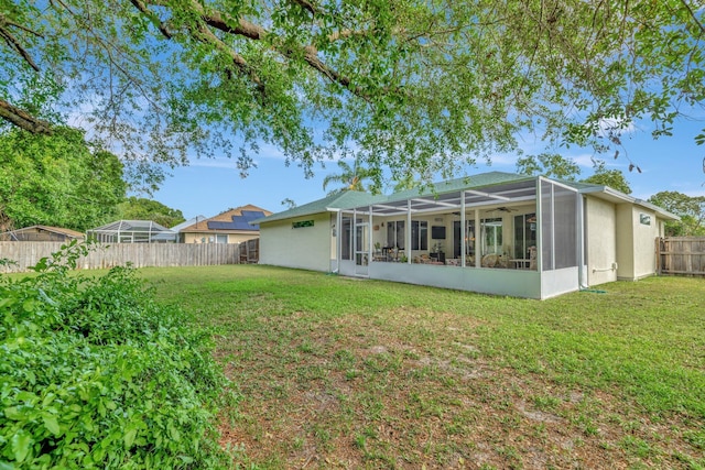 2857 SE Pace Dr, Port Saint Lucie, FL 34984 - back of property with a yard, a fenced backyard, and stucco siding