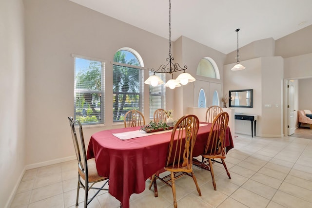 2857 SE Pace Dr, Port Saint Lucie, FL 34984 - dining room with high vaulted ceiling, light tile patterned floors, a notable chandelier, and baseboards