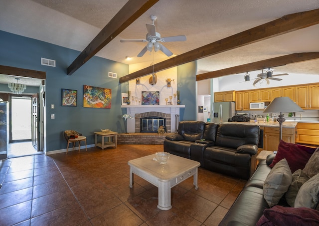 living room featuring a textured ceiling, ceiling fan, baseboards, and visible vents