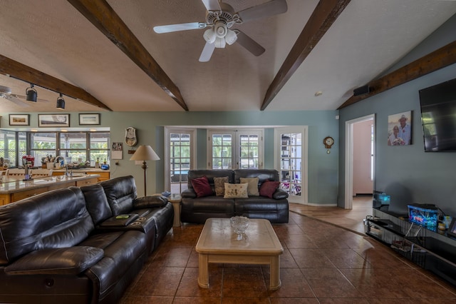 living room featuring tile patterned floors, ceiling fan, baseboards, and lofted ceiling with beams