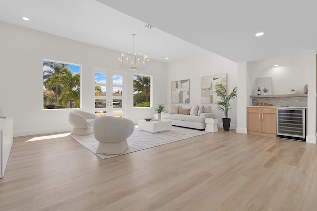 841 SE 5th Ter, Pompano Beach, FL 33060 - living area with a wealth of natural light, a notable chandelier, light wood-style floors, and wine cooler