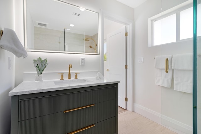 841 SE 5th Ter, Pompano Beach, FL 33060 - bathroom with wood finished floors, vanity, baseboards, an enclosed shower, and visible vents