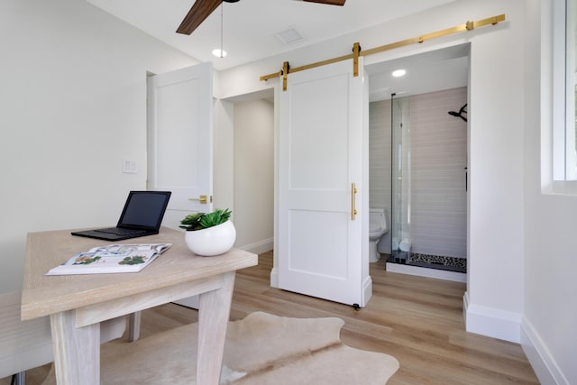 841 SE 5th Ter, Pompano Beach, FL 33060 - office space featuring a barn door, a ceiling fan, light wood finished floors, baseboards, and visible vents