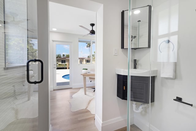 841 SE 5th Ter, Pompano Beach, FL 33060 - full bathroom featuring baseboards, a ceiling fan, wood finished floors, a shower stall, and vanity