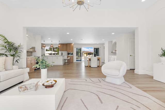 841 SE 5th Ter, Pompano Beach, FL 33060 - living area featuring baseboards, an inviting chandelier, light wood-style floors, and recessed lighting