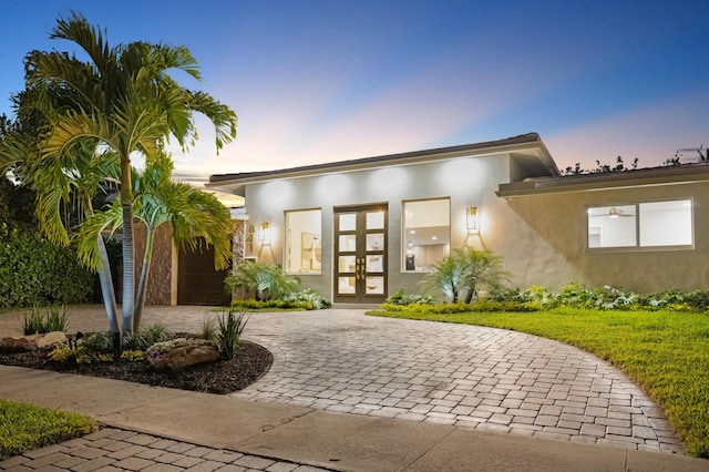 841 SE 5th Ter, Pompano Beach, FL 33060 - property entrance featuring french doors, curved driveway, and stucco siding