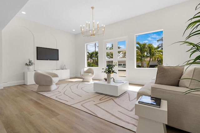 841 SE 5th Ter, Pompano Beach, FL 33060 - living area with light wood finished floors, baseboards, recessed lighting, and a notable chandelier