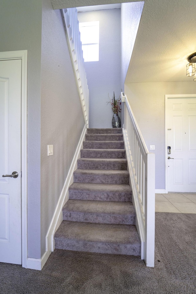 stairs with carpet flooring and baseboards