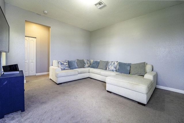 living area with baseboards, visible vents, and carpet floors