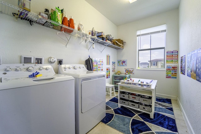 laundry area with separate washer and dryer, baseboards, and laundry area
