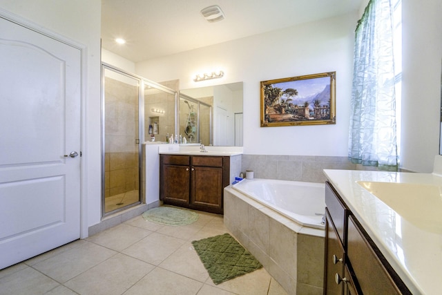 full bath featuring a shower stall, tile patterned floors, a sink, a bath, and two vanities
