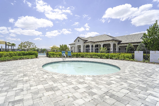 view of pool featuring a swimming pool and fence