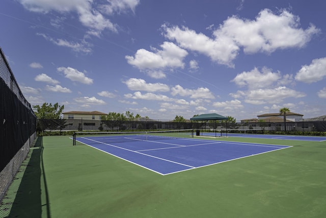 view of tennis court with fence