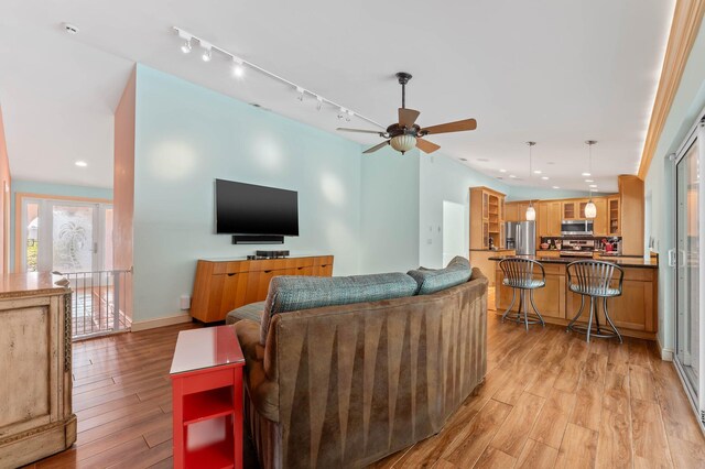 living area featuring light wood-type flooring, baseboards, recessed lighting, ceiling fan, and track lighting