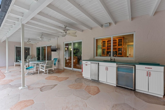 view of patio / terrace featuring a ceiling fan, a sink, and outdoor dining area