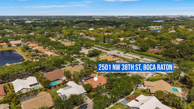 birds eye view of property with a water view and a residential view