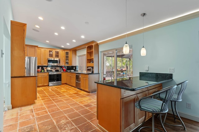 kitchen with decorative backsplash, a breakfast bar area, a peninsula, appliances with stainless steel finishes, and recessed lighting
