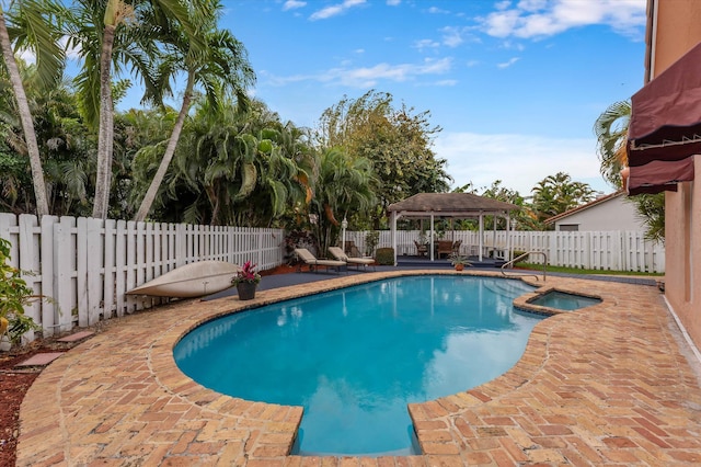 view of pool with a gazebo, a patio, a pool with connected hot tub, and a fenced backyard