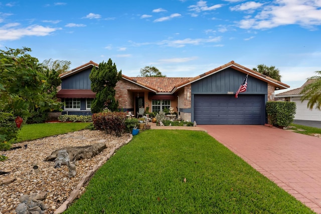 single story home with concrete driveway, a front yard, an attached garage, and a tile roof