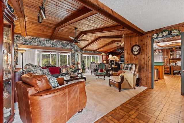 living room featuring wooden walls, wooden ceiling, ceiling fan, and vaulted ceiling with beams