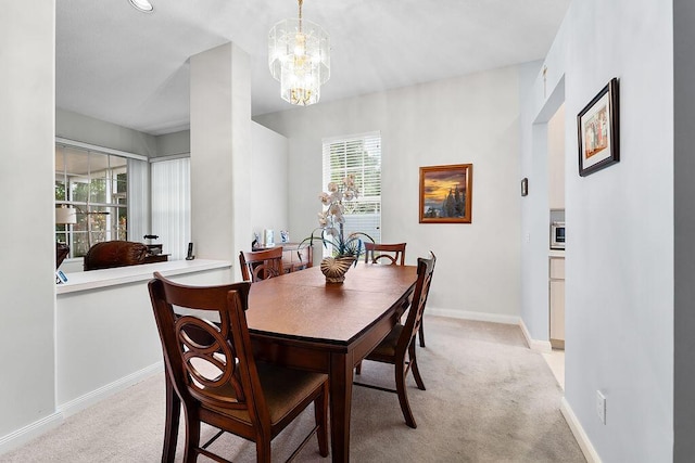 5166 SE Inkwood Way, Hobe Sound, FL 33455 - dining area with a chandelier, light colored carpet, and baseboards