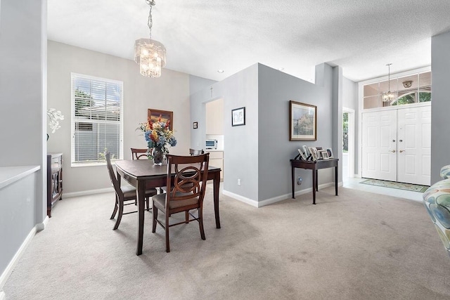 5166 SE Inkwood Way, Hobe Sound, FL 33455 - dining area featuring baseboards, a chandelier, and light carpet