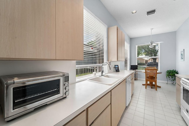 5166 SE Inkwood Way, Hobe Sound, FL 33455 - kitchen featuring visible vents, light brown cabinets, a sink, light countertops, and white appliances