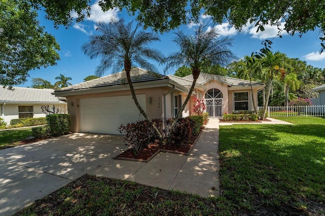 5166 SE Inkwood Way, Hobe Sound, FL 33455 - view of front of home featuring stucco siding, a tiled roof, fence, and an attached garage