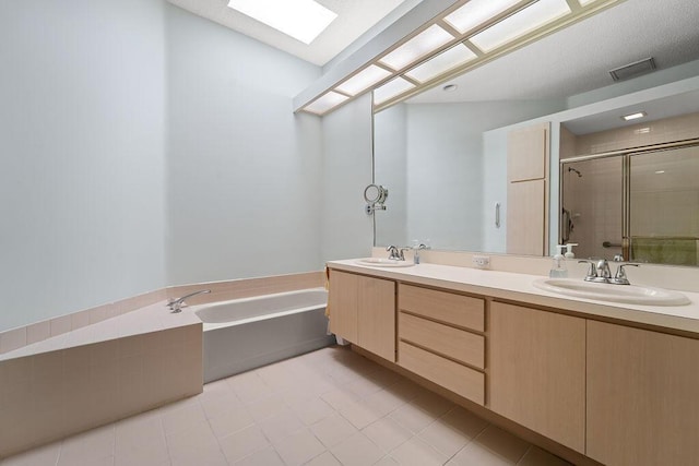 5166 SE Inkwood Way, Hobe Sound, FL 33455 - bathroom featuring visible vents, a sink, double vanity, a stall shower, and a garden tub