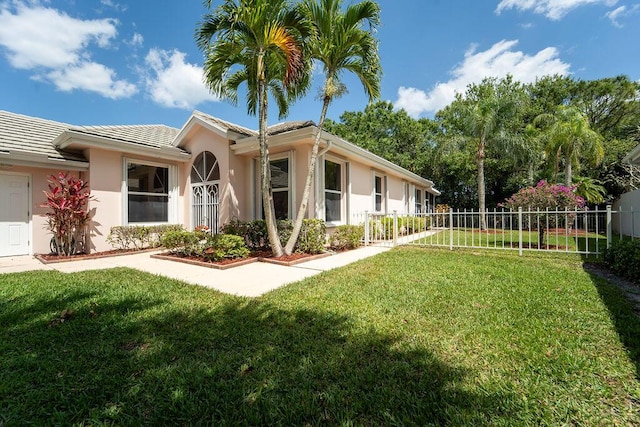 5166 SE Inkwood Way, Hobe Sound, FL 33455 - exterior space with stucco siding, fence, a front lawn, and a tile roof