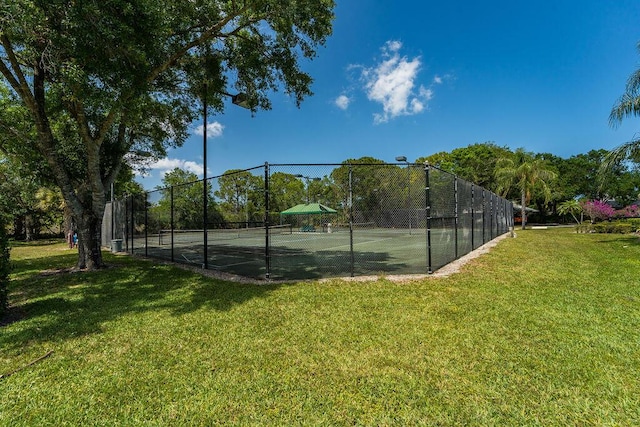 5166 SE Inkwood Way, Hobe Sound, FL 33455 - view of sport court with fence and a lawn
