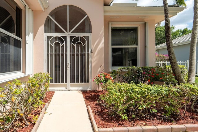 5166 SE Inkwood Way, Hobe Sound, FL 33455 - doorway to property with stucco siding