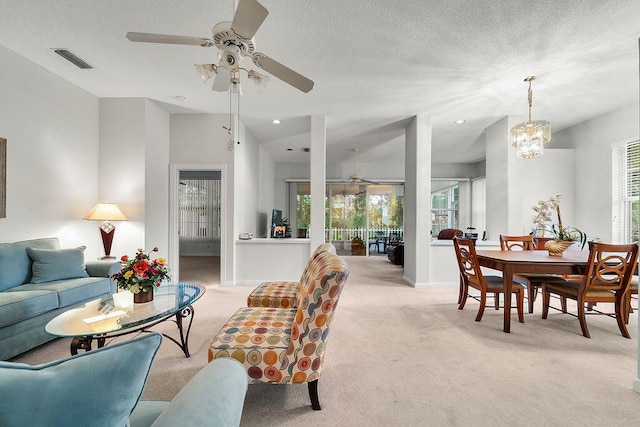 5166 SE Inkwood Way, Hobe Sound, FL 33455 - living area with light carpet, ceiling fan, visible vents, and plenty of natural light