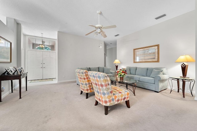 5166 SE Inkwood Way, Hobe Sound, FL 33455 - carpeted living room with visible vents, baseboards, and a ceiling fan